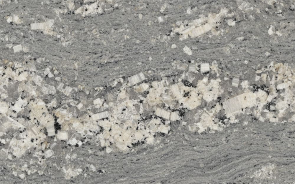 Persian Pearl granite — polished slab surface showing Grey coloring. Origin: India. Hardness: 6 Mohs. Acid sensitivity: none.