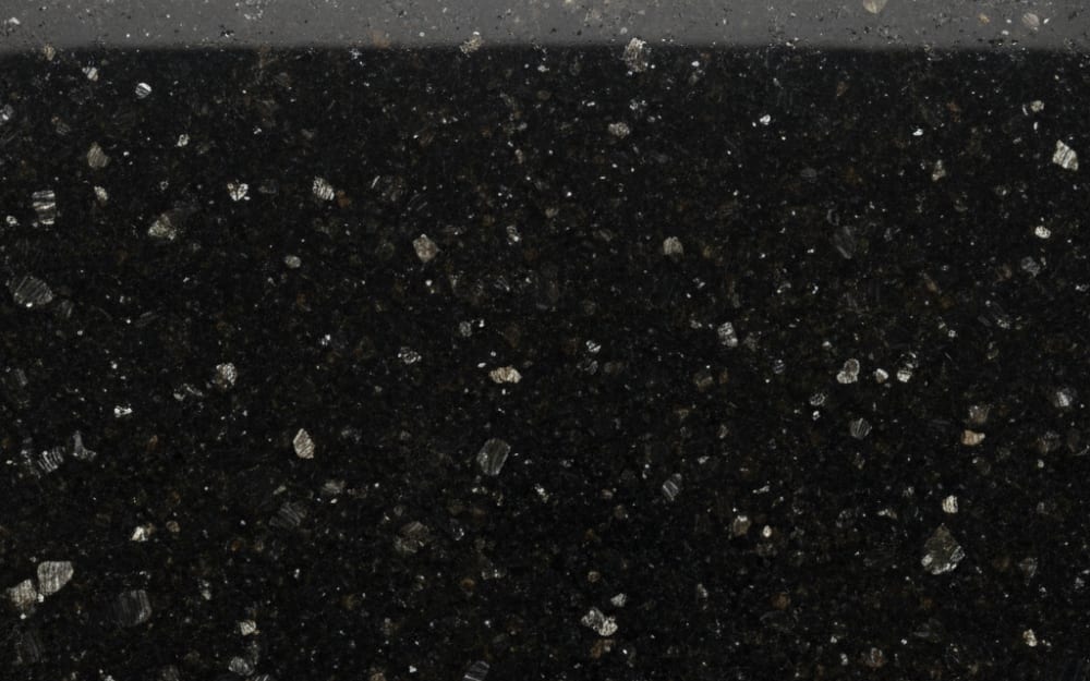 Royal Black granite — polished slab surface showing Black coloring. Origin: India. Hardness: 6 Mohs. Acid sensitivity: none.
