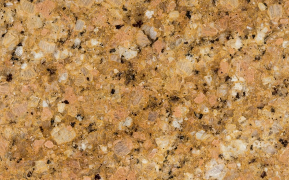 Rustic Gold granite — polished slab surface showing Gold/Yellow coloring. Origin: Brazil. Hardness: 6 Mohs. Acid sensitivity: none.