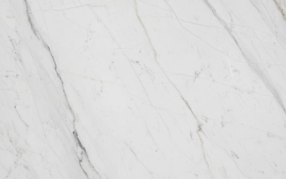 Sahara Blanc marble — polished slab surface showing White coloring. Origin: Morocco / Tunisia. Hardness: 3 Mohs. Acid sensitivity: high.