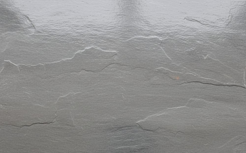 Silver Grey Slate slate — polished slab surface showing Grey coloring. Origin: Brazil / India. Hardness: 2.5 Mohs. Acid sensitivity: medium.