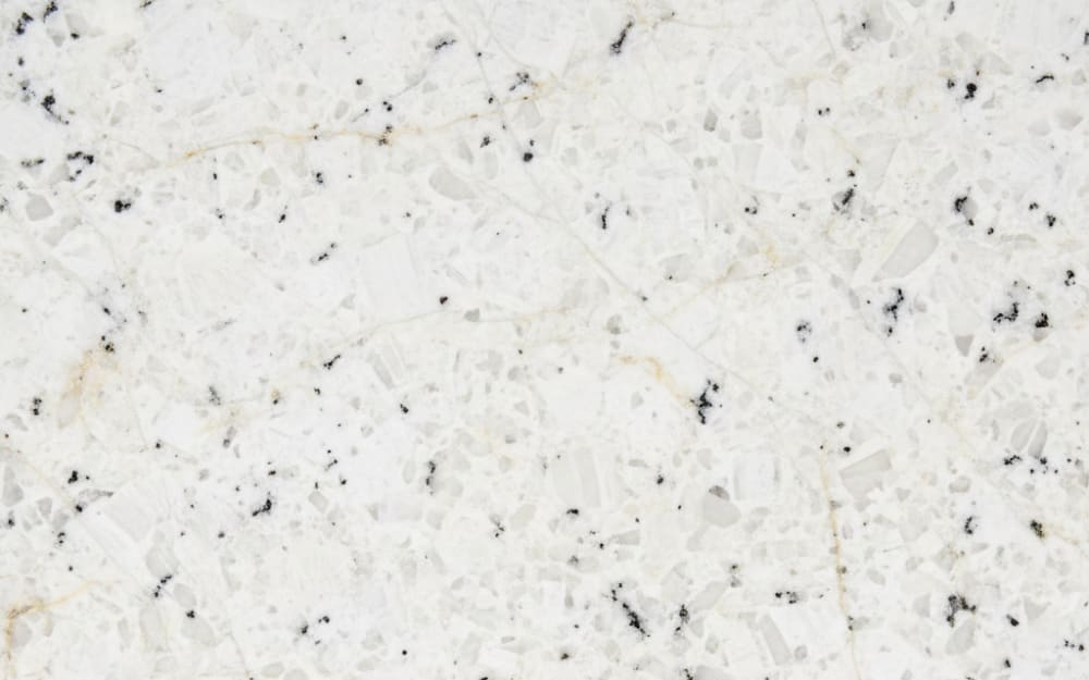 Spokane White granite — polished slab surface showing White coloring. Origin: India / Brazil. Hardness: 6 Mohs. Acid sensitivity: none.