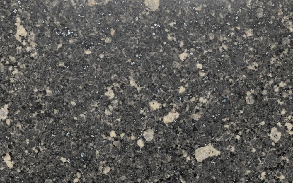 Steel Gray granite — polished slab surface showing Grey coloring. Origin: India (Telangana — Karimnagar). Hardness: 6 Mohs. Acid sensitivity: none.