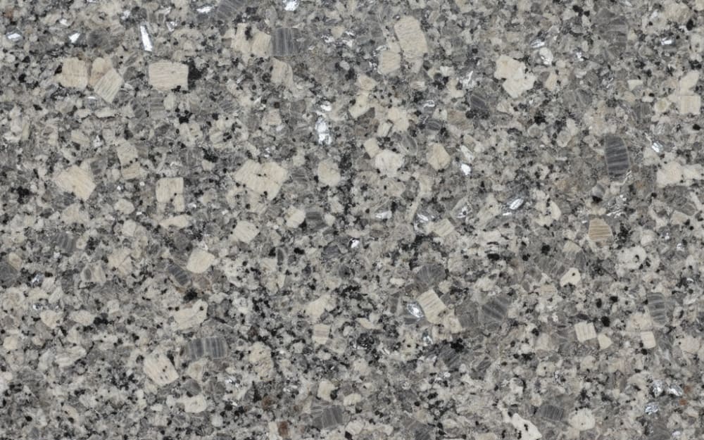 Sucuri granite — polished slab surface showing Grey coloring. Origin: Brazil. Hardness: 6 Mohs. Acid sensitivity: none.