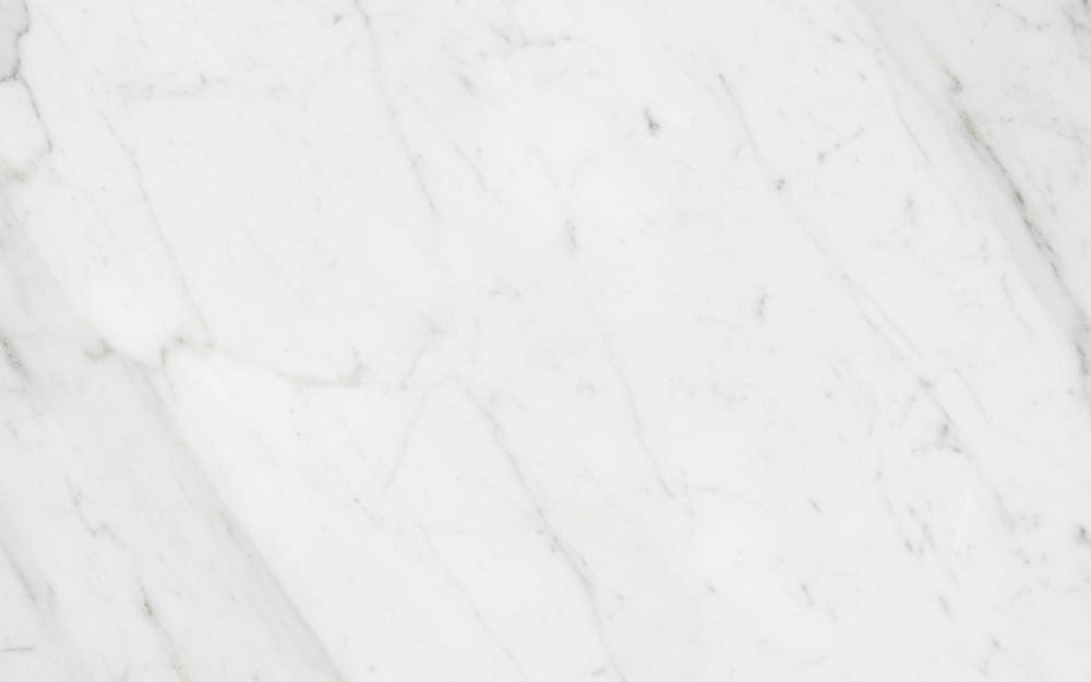 Thassos White marble — polished slab surface showing White coloring. Origin: Greece (Thassos Island). Hardness: 3 Mohs. Acid sensitivity: high.