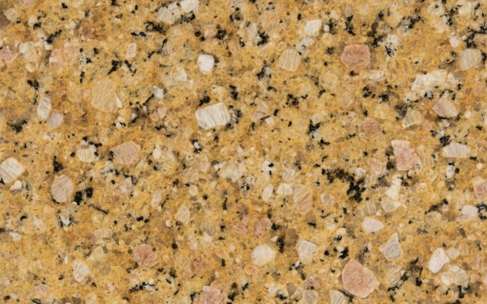 Vienna Gold granite — polished slab surface showing Gold/Yellow coloring. Origin: Brazil. Hardness: 6 Mohs. Acid sensitivity: none.