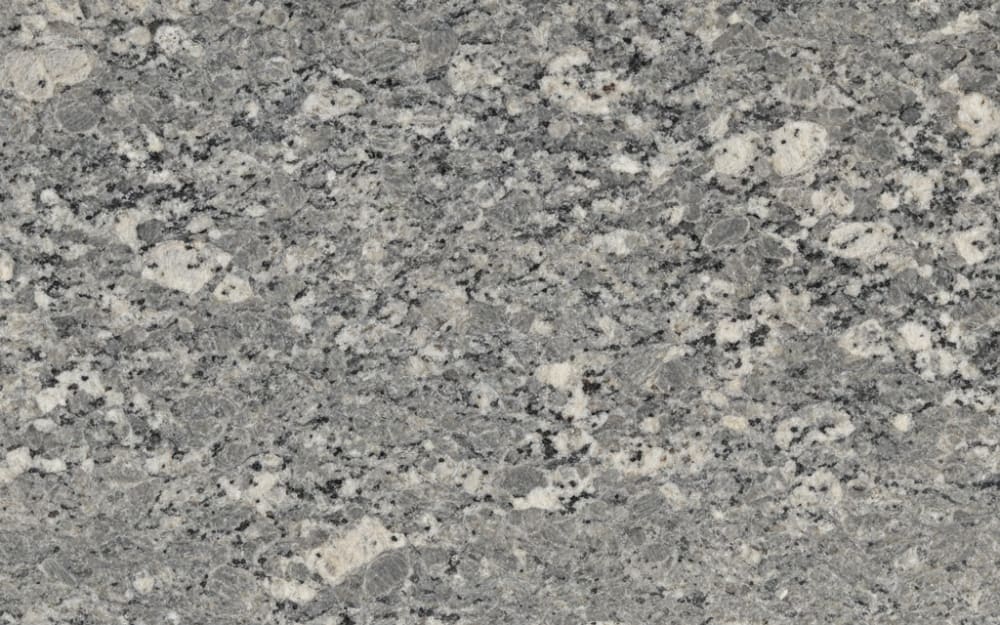 Virginia Mist granite — polished slab surface showing Grey coloring. Origin: USA (Virginia). Hardness: 6 Mohs. Acid sensitivity: none.