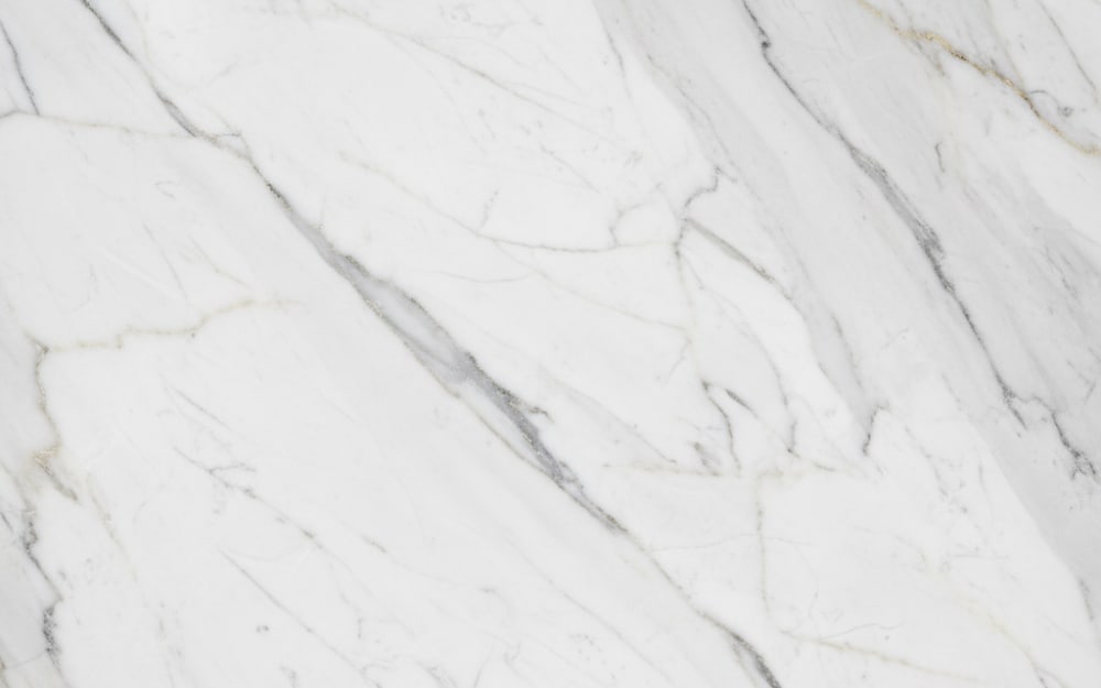Volakas White marble — polished slab surface showing White coloring. Origin: Greece (Drama region). Hardness: 3 Mohs. Acid sensitivity: high.