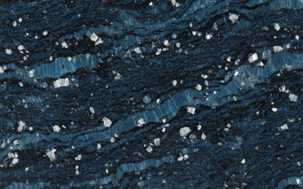 Volga Blue granite — polished slab surface showing Blue coloring. Origin: Ukraine (Zhytomyr Oblast). Hardness: 6 Mohs. Acid sensitivity: none.