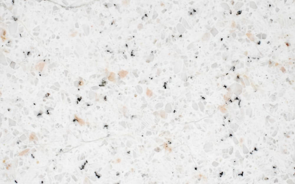 White Ornamental granite — polished slab surface showing White coloring. Origin: Brazil. Hardness: 6 Mohs. Acid sensitivity: none.
