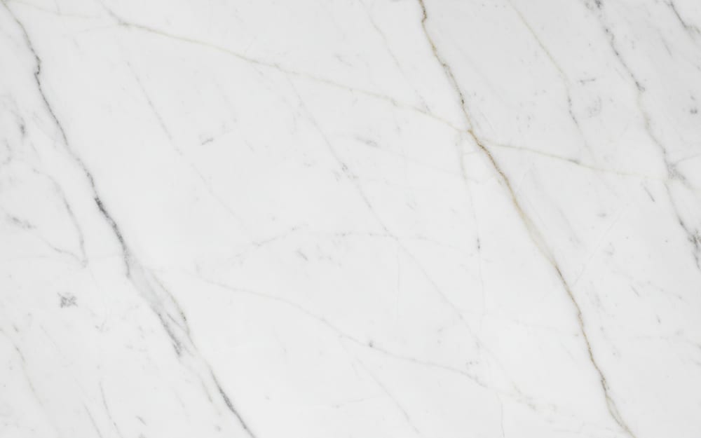 White Thassos marble — polished slab surface showing White coloring. Origin: Greece (Thassos). Hardness: 3 Mohs. Acid sensitivity: high.
