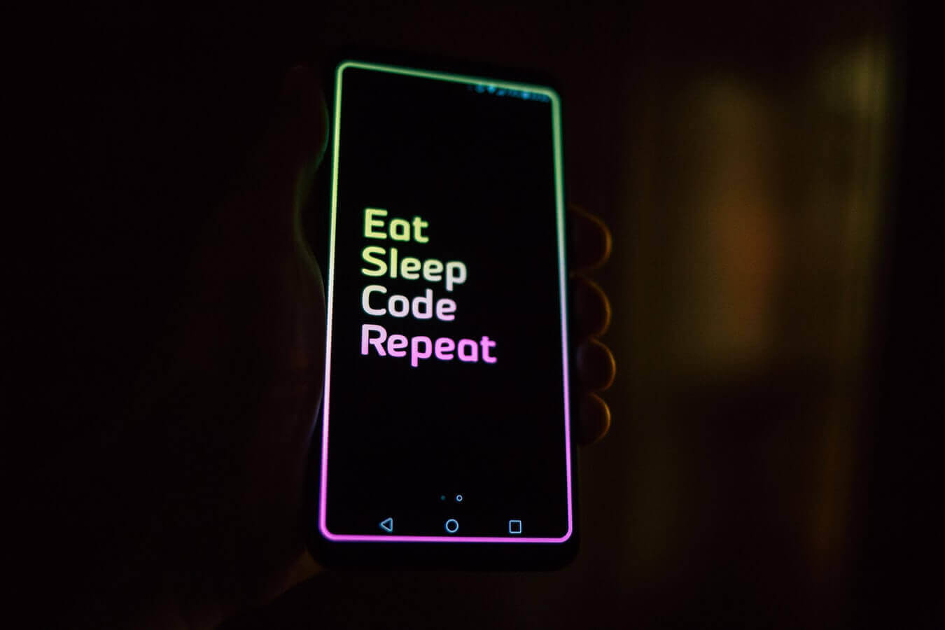 Mobile with eat sleep code repeat on the screen