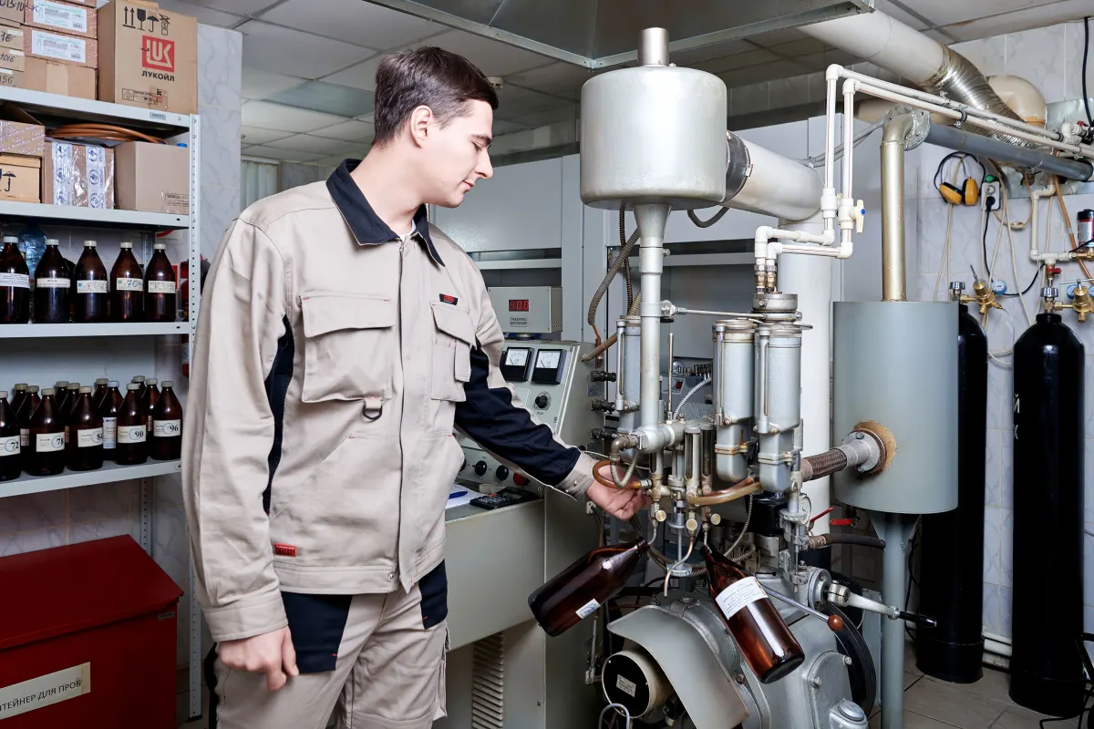 Инженер проводит испытание топлива на определение детонационного числа бензина моторным методом в нефтехимической лаборатории Нефтехим-Эксп