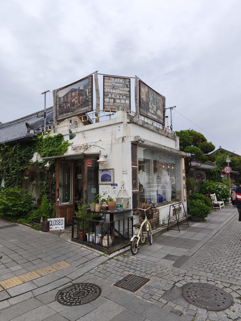 Vintage storefront of Haruilgi shop in Jeonju Hanok Village with a faded bicycle