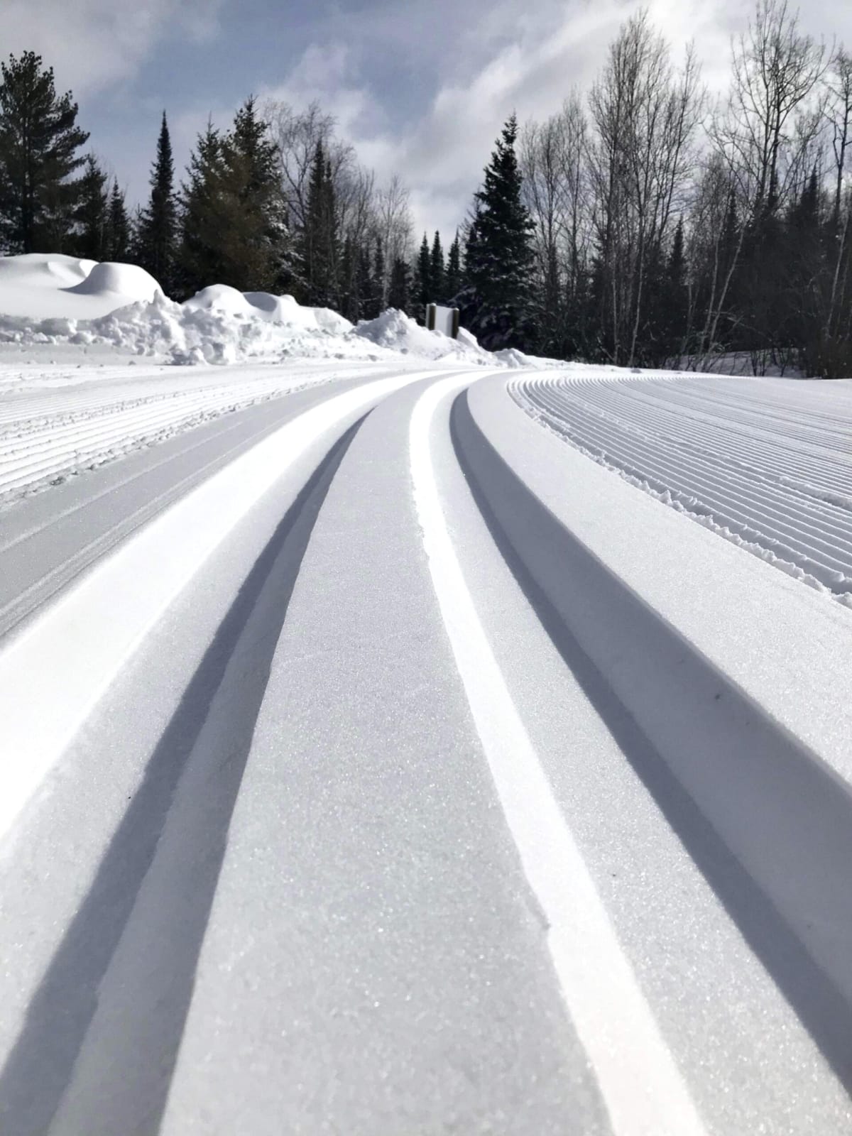 cross country ski tracks snow covered road