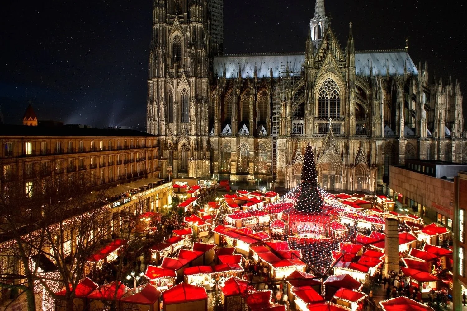 German Christmas market stalls with cathedral backdrop