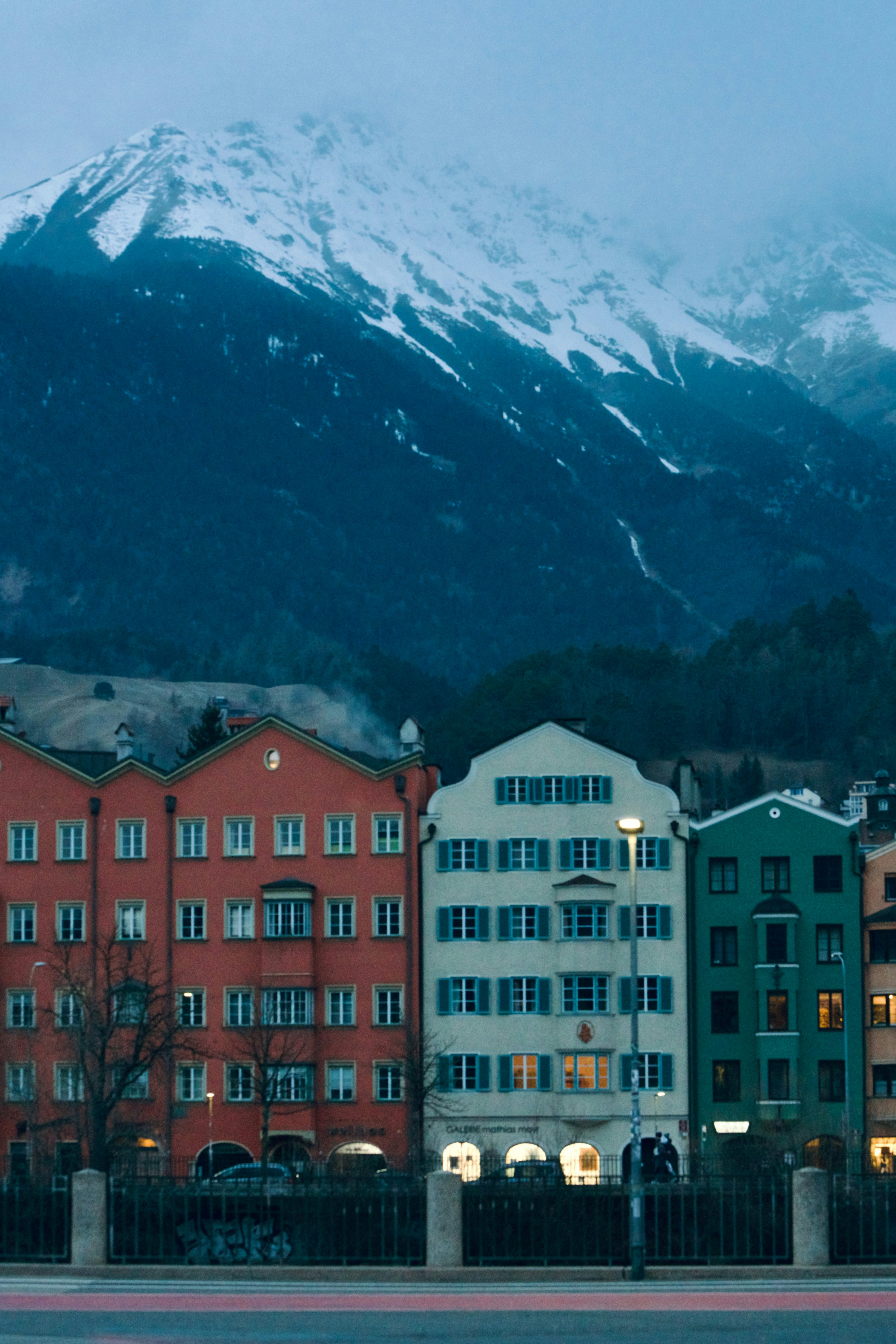 innsbruck austria winter snowy mountains colorful buildings