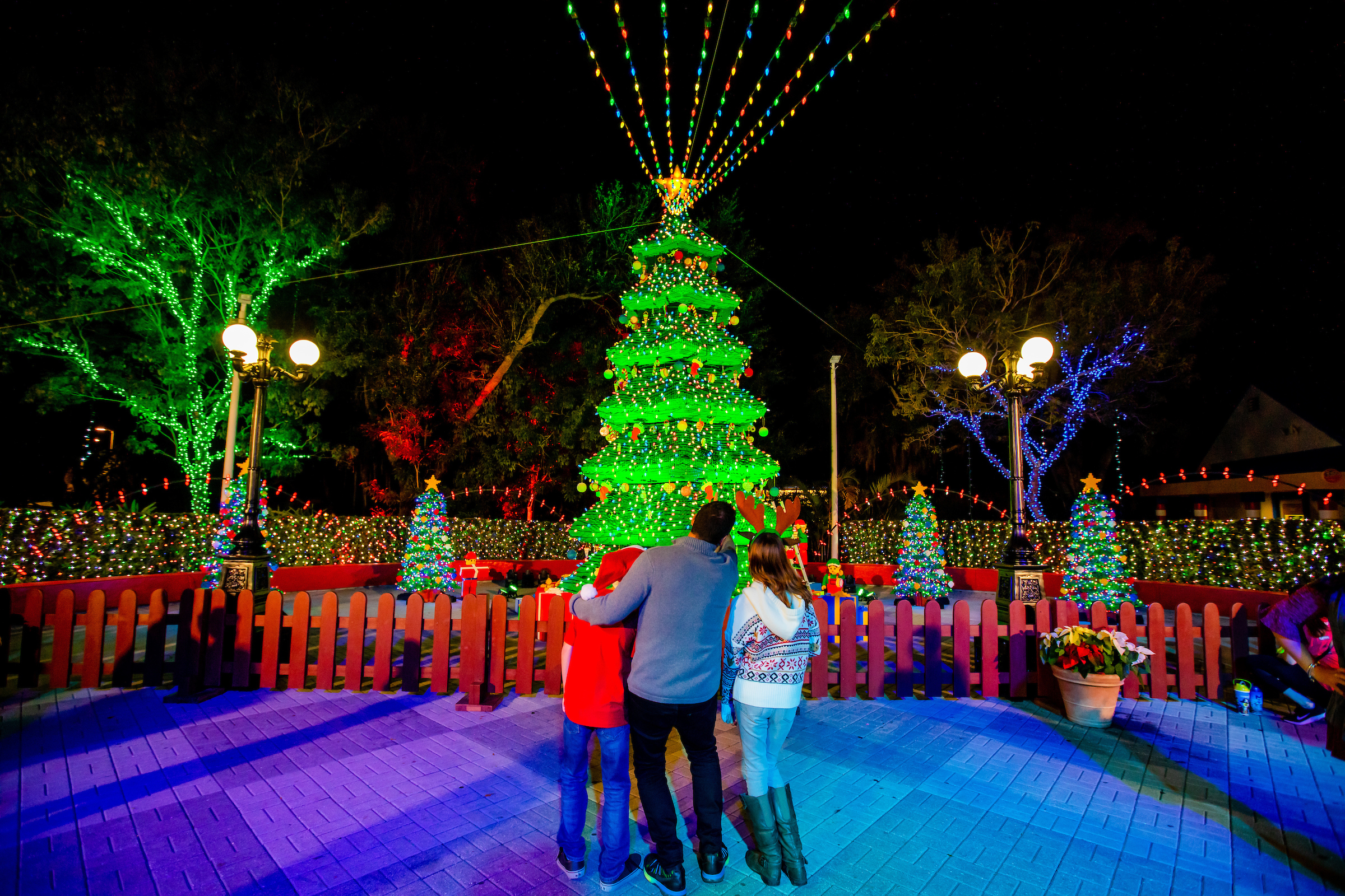 family at Christmas resort holiday lights display