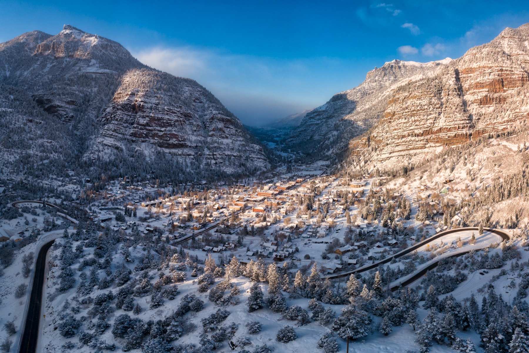 steam rising from outdoor mineral pool in snow