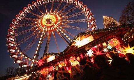German Christmas market stalls at dusk with mulled wine and lights
