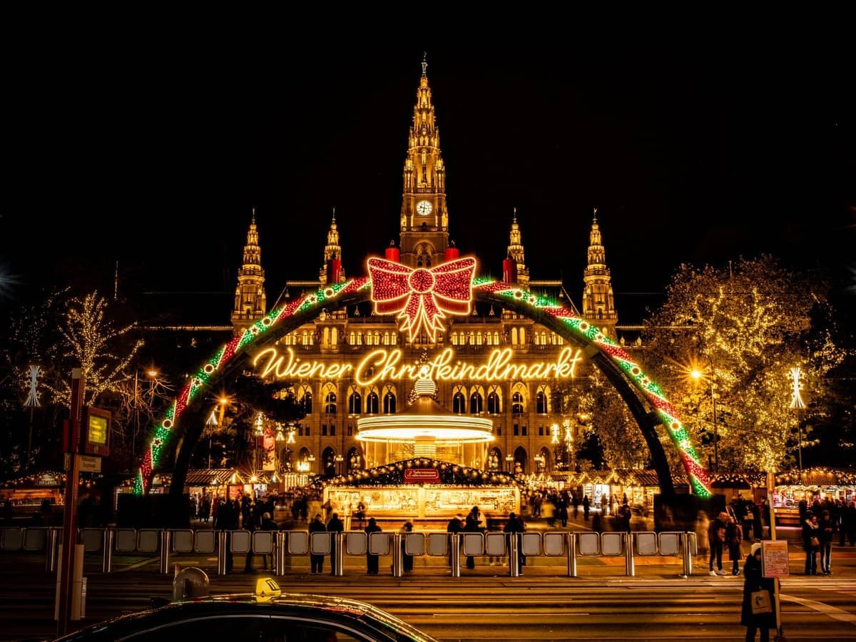 crowded holiday market at night with twinkling lights