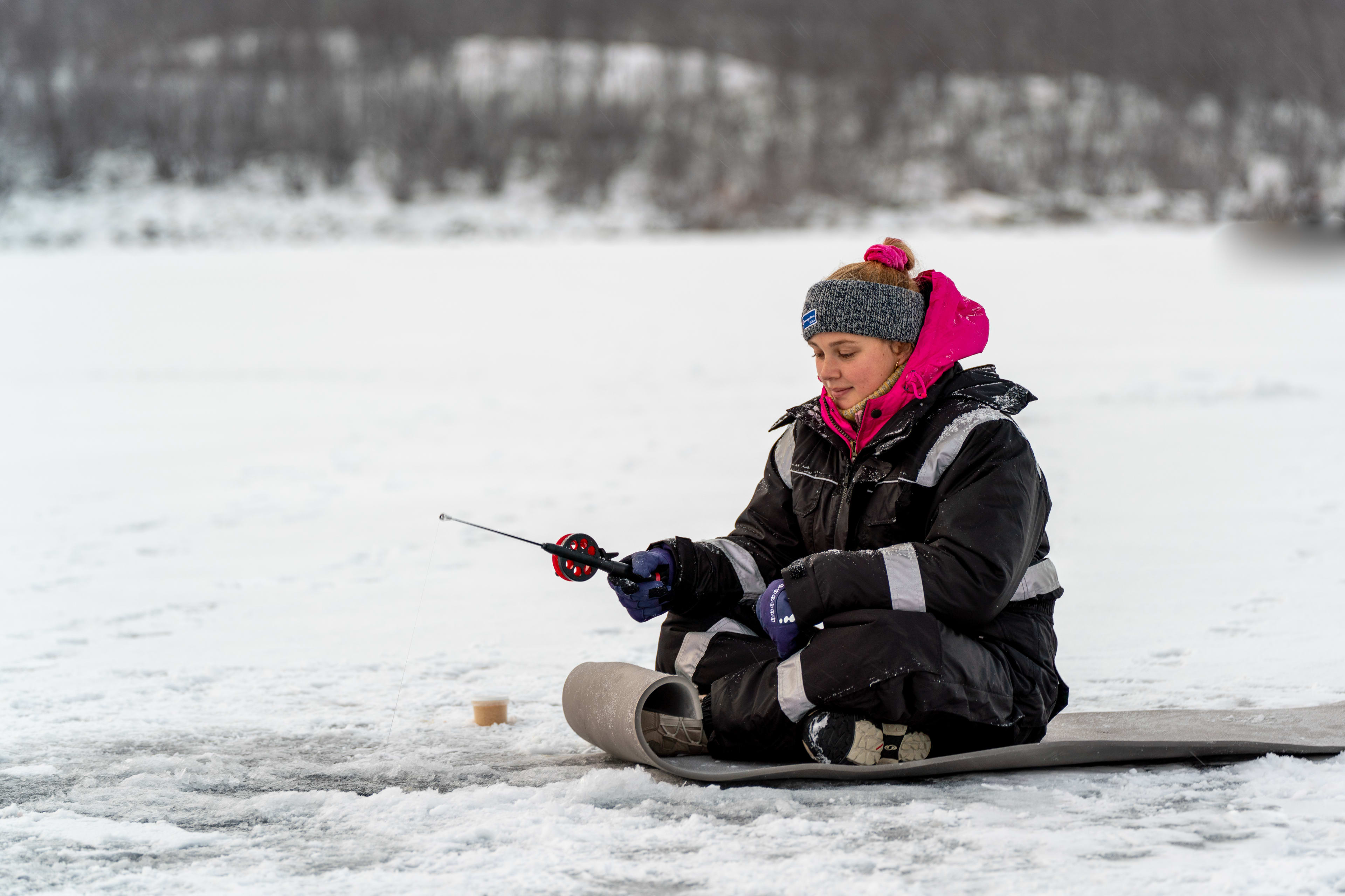 ice fishing frozen lake lapland