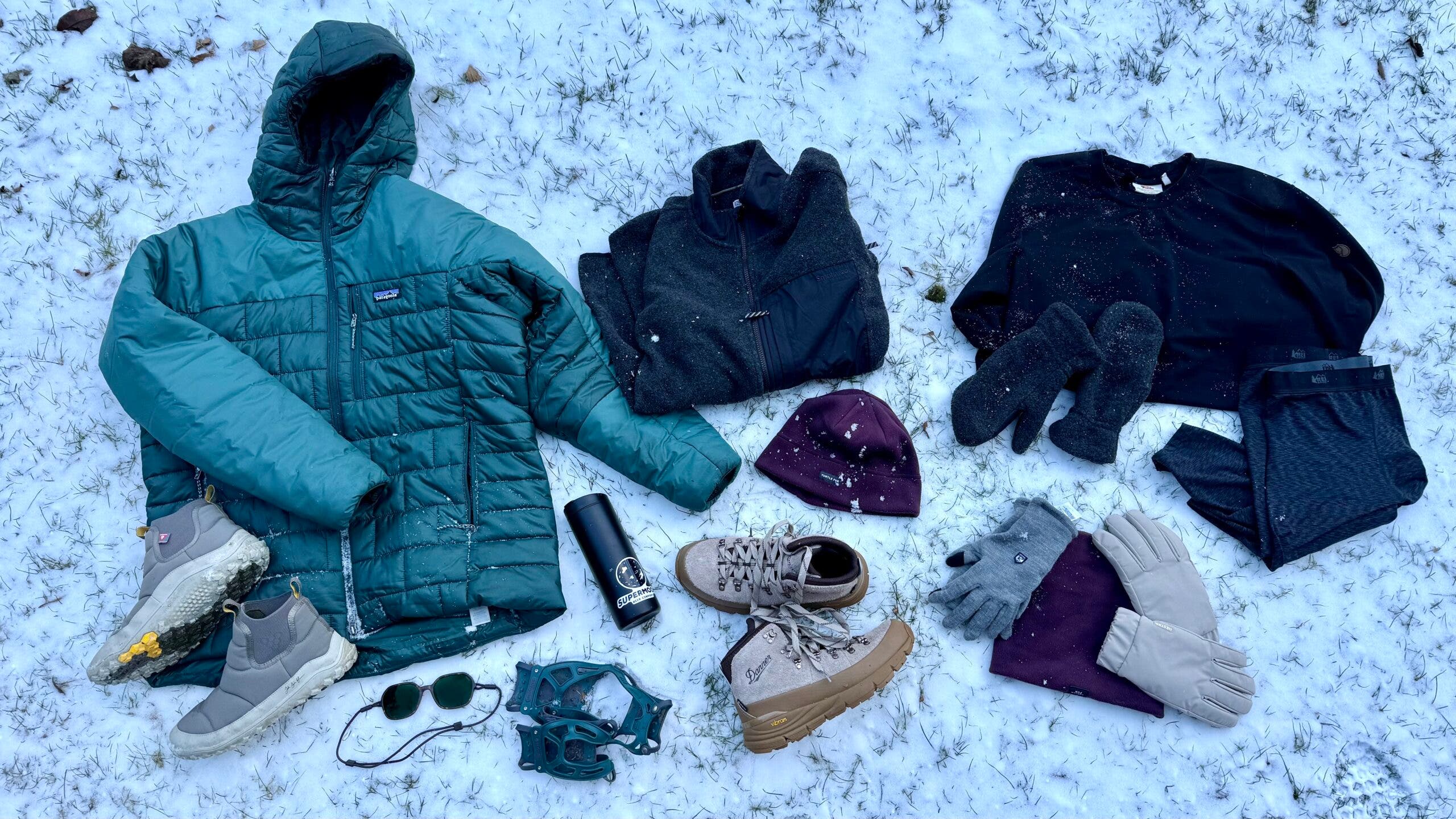 arctic winter clothing layers flat lay