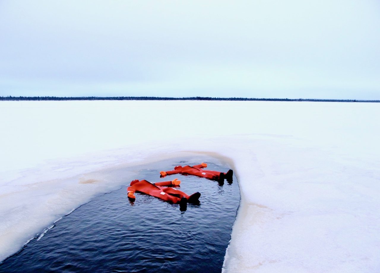 ice floating frozen lake survival suit Lapland
