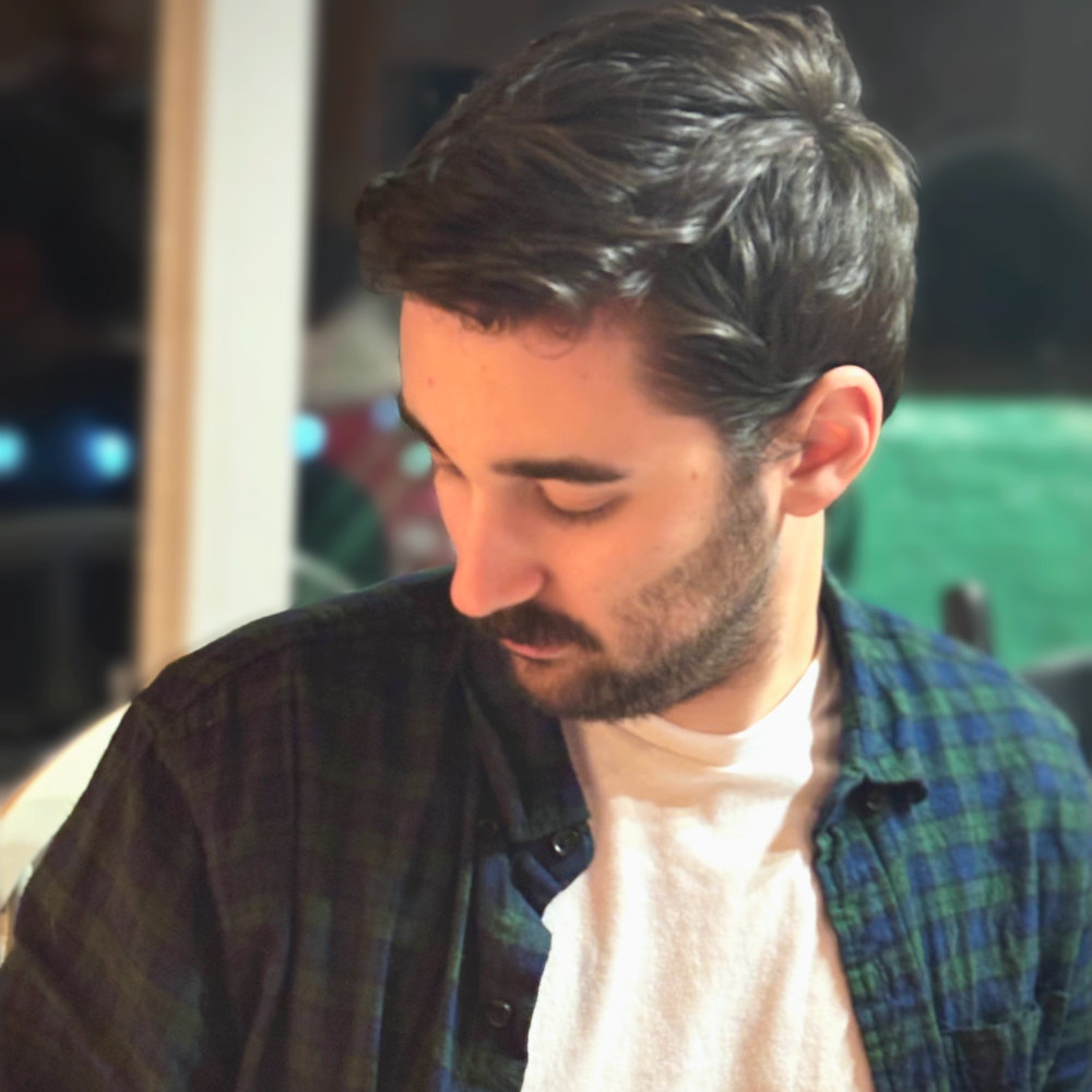 Candid polaroid of Luke Fair relaxing at a cottage, casually looking out of frame