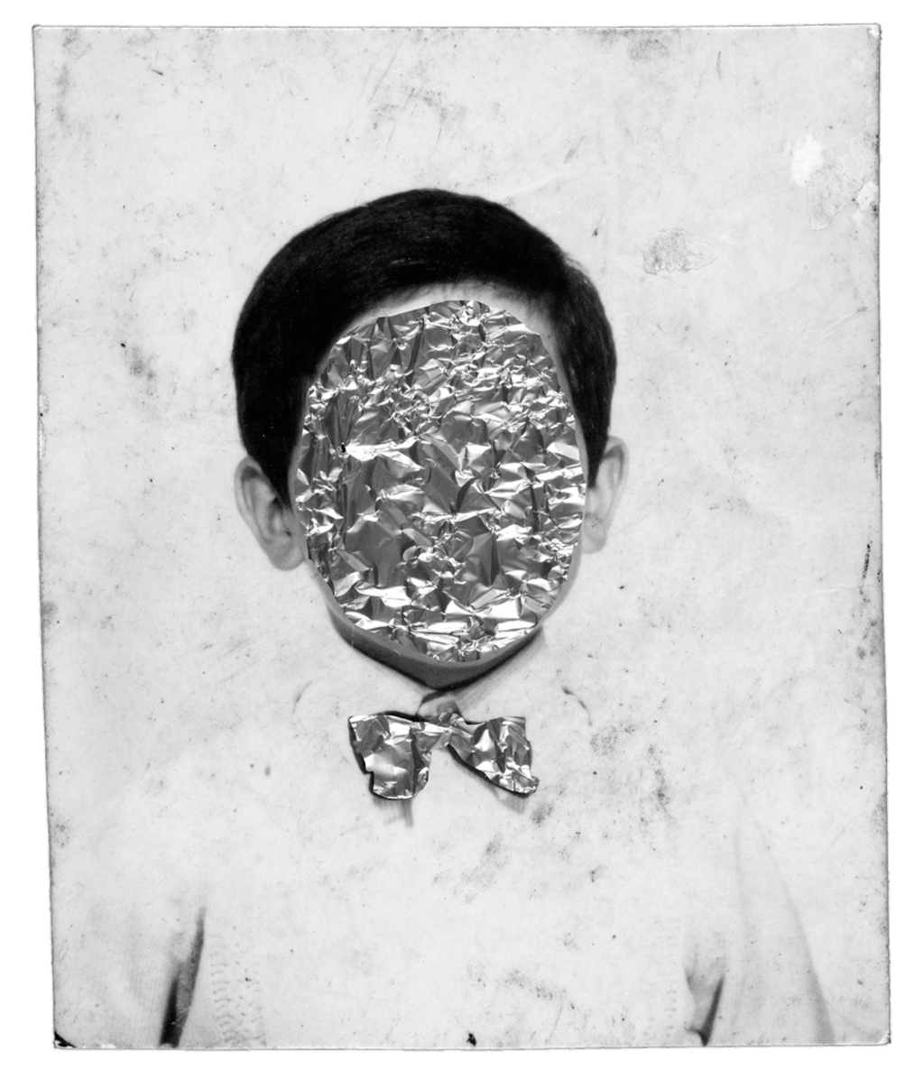Child's portrait, the face covered with crumpled foil.