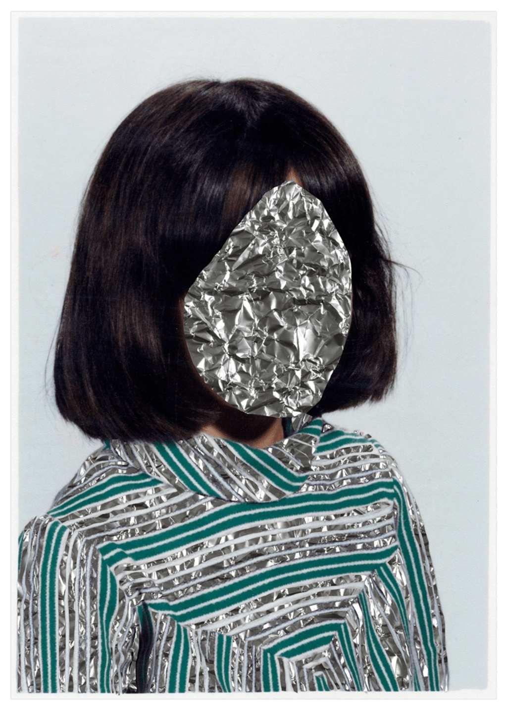 Portrait of a woman, the face covered with crumpled foil.