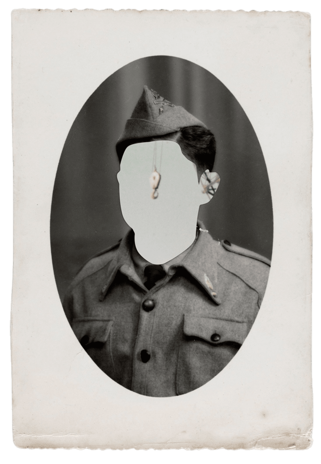 Oval military portrait, the face blanked out in grey.
