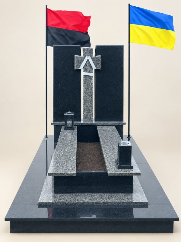 Військовий памʼятник із двох плит з прапором і різьбленим хрестом, чорний габро та сірий граніт