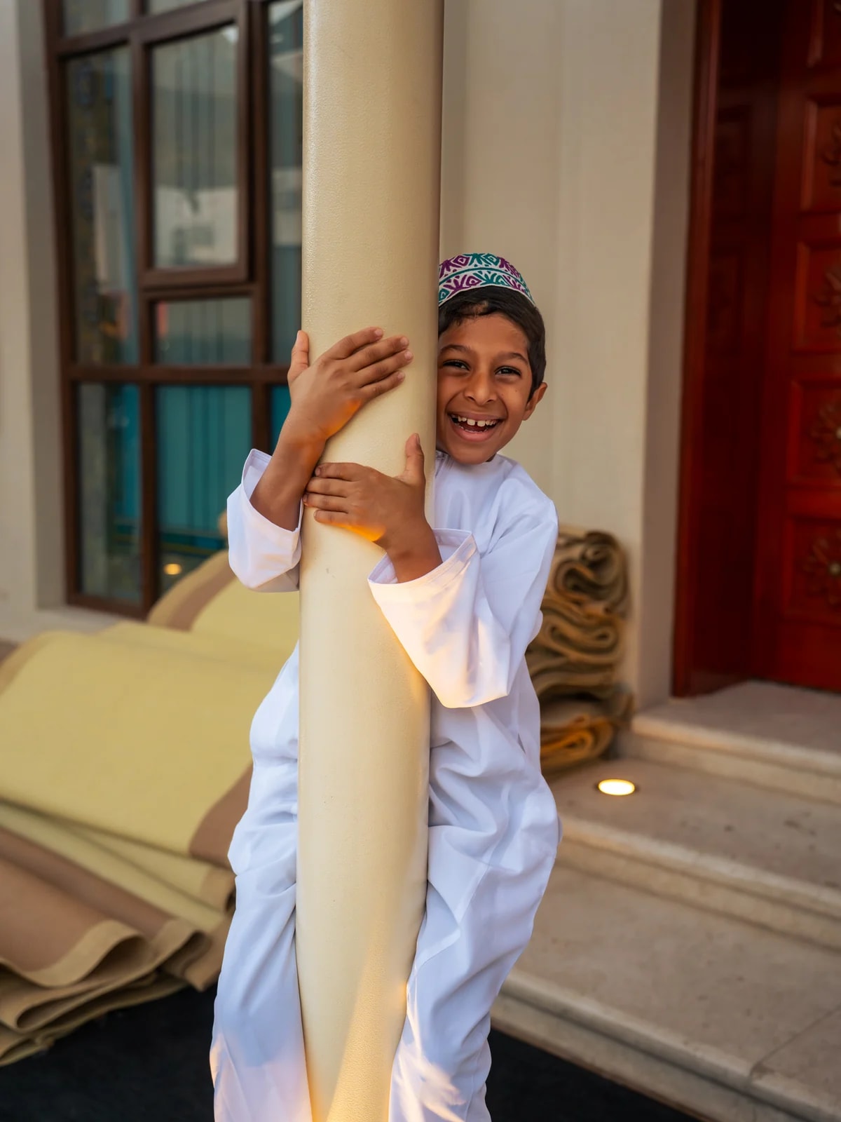 Close-up portrait of another boy near Mutrah Souq mosque