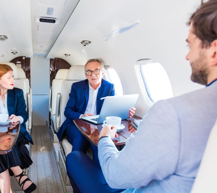 Business executives in a meeting inside a private jet cabin