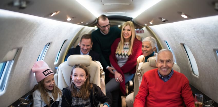 A family of multiple generations celebrating together in a private jet cabin