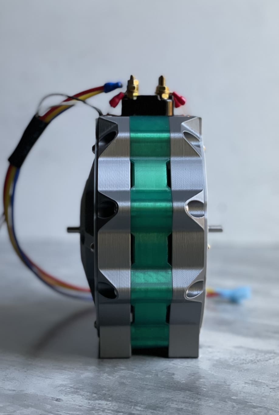 Engineer routing wires through a Torev electric motor prototype during assembly
