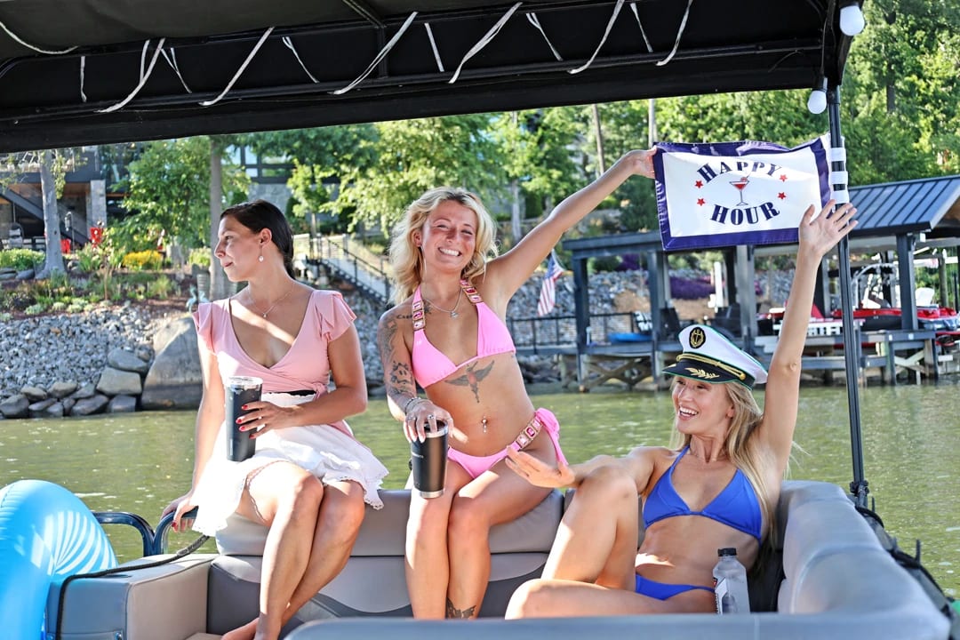 Group toasting happy hour aboard the pontoon