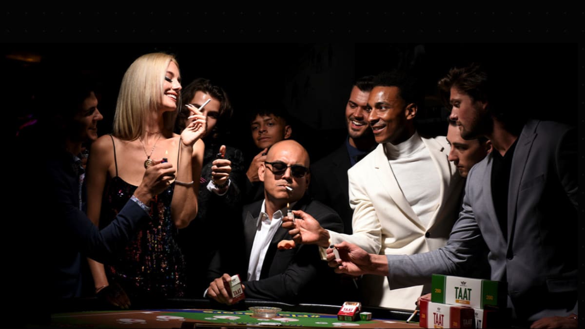 Friends at a casino table at night with a pack of TAAT