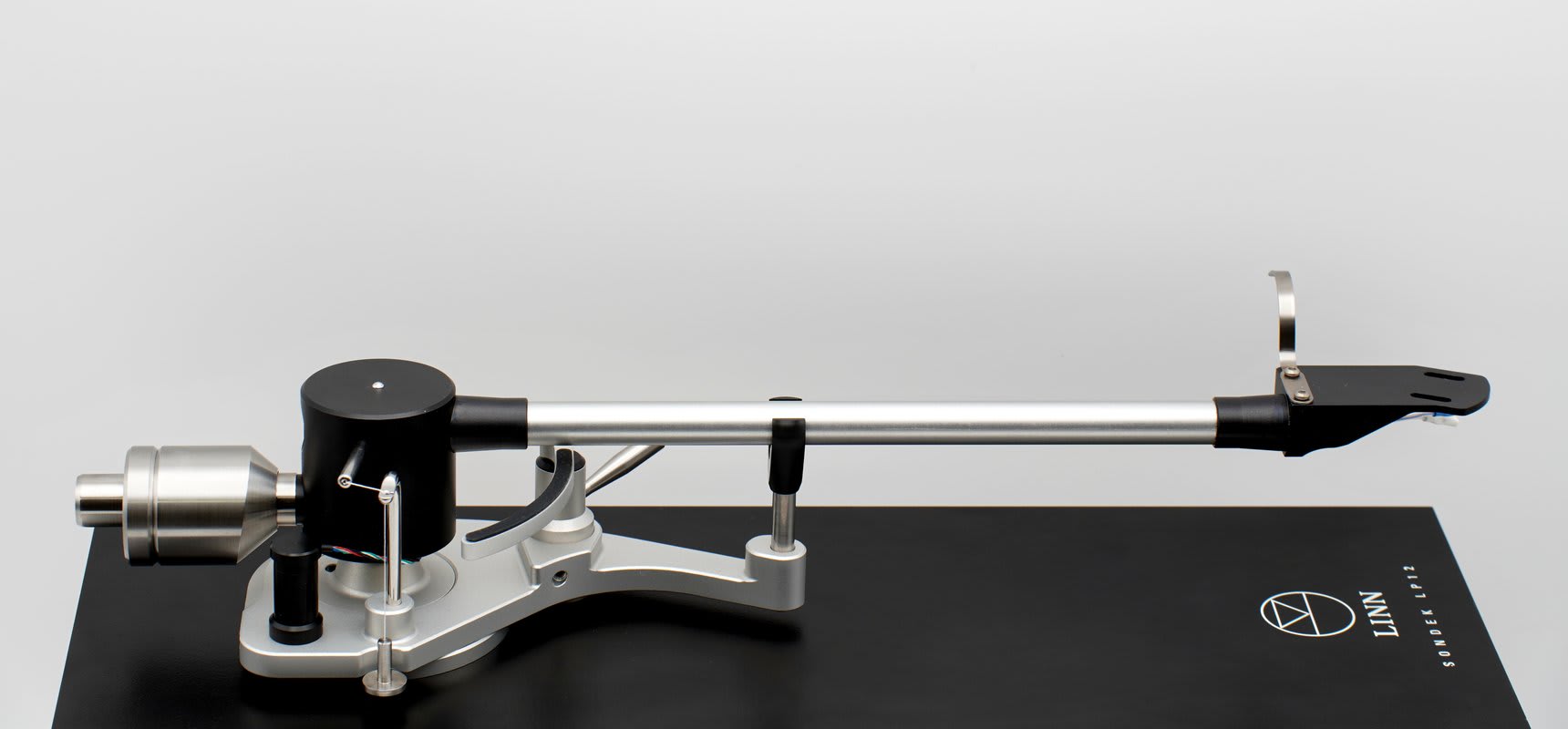 The Clear Wave tonearm photographed side on, its arm tube running from the pivot housing out to the headshell