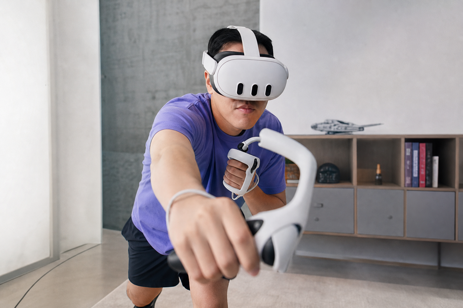 A VR player in a small room looking down at a tangled long arm accessory that hit a piece of furniture.