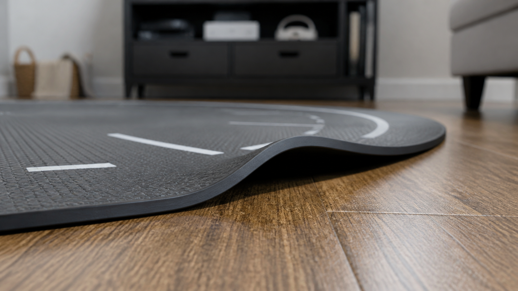 A close-up shot of a VR mat's edge slightly curled up from the floor, creating a potential tripping hazard