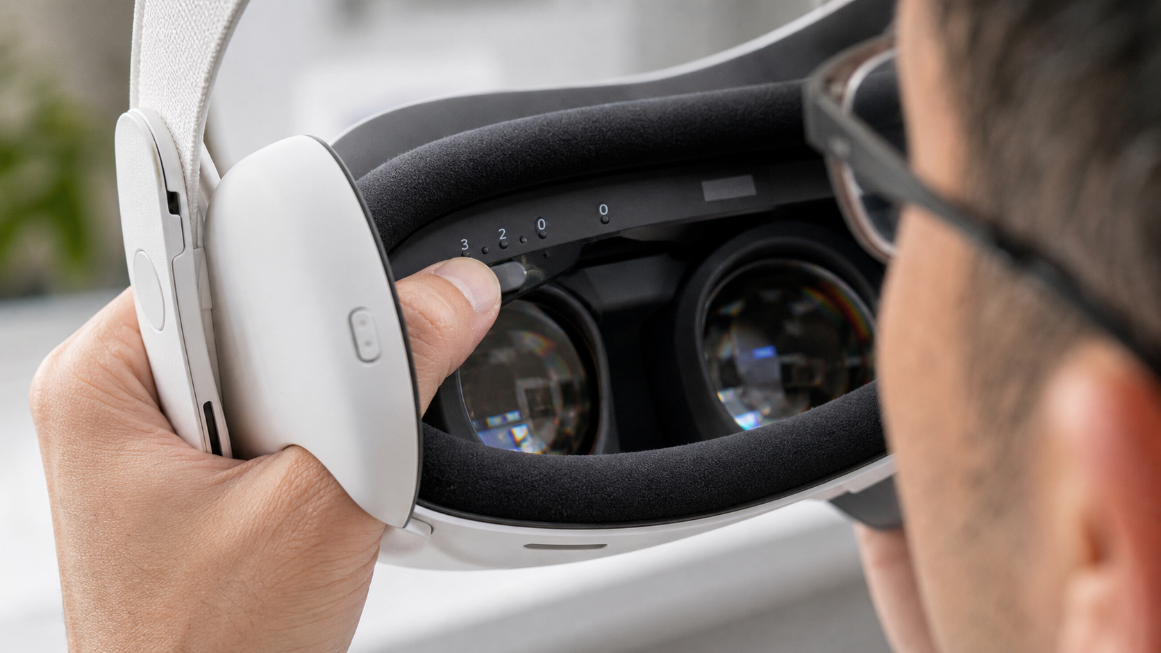A close-up of a user pressing the depth adjustment buttons inside a Quest 3 to make more room for their glasses.