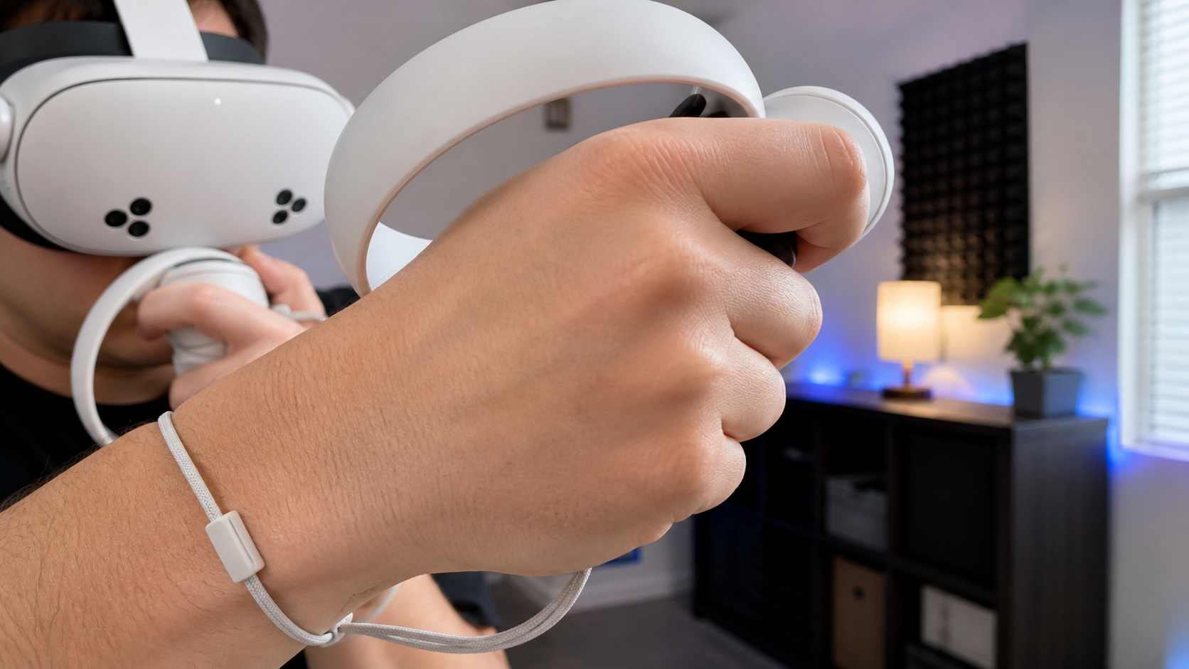 Close-up view of a player's hands with VR controllers where the front hand is blocking the headset's view.