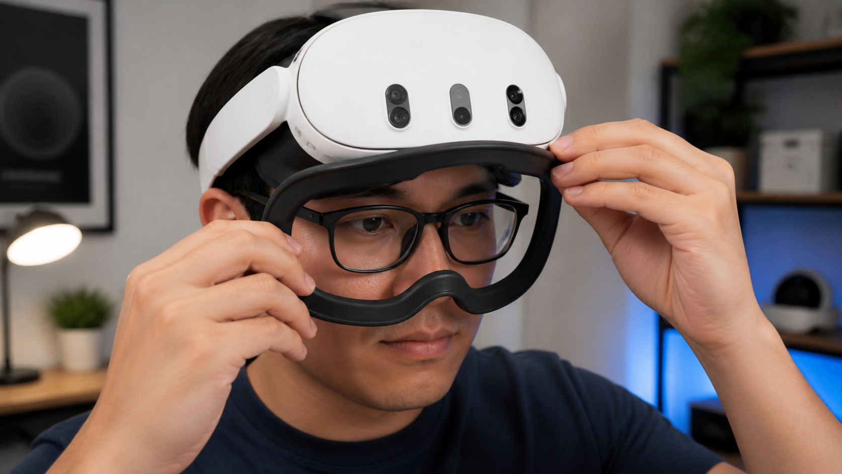 A person with glasses carefully adjusting the fit of an open facial interface on their VR headset