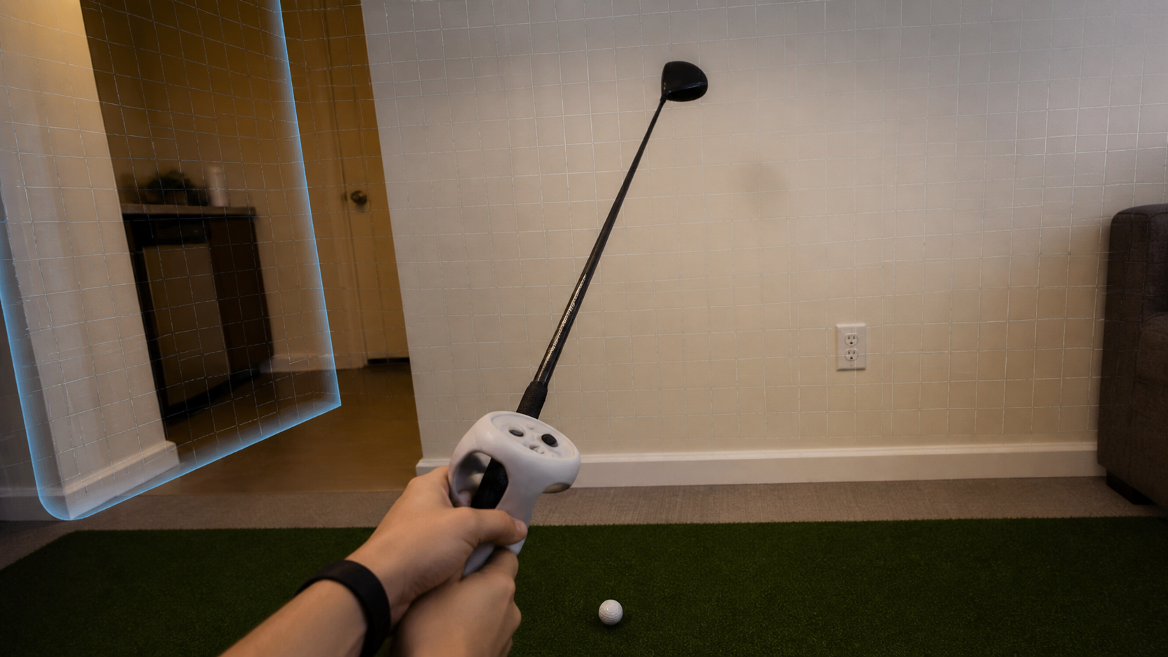 Player's first-person view in VR showing the golf club and a pass-through view of a nearby apartment wall