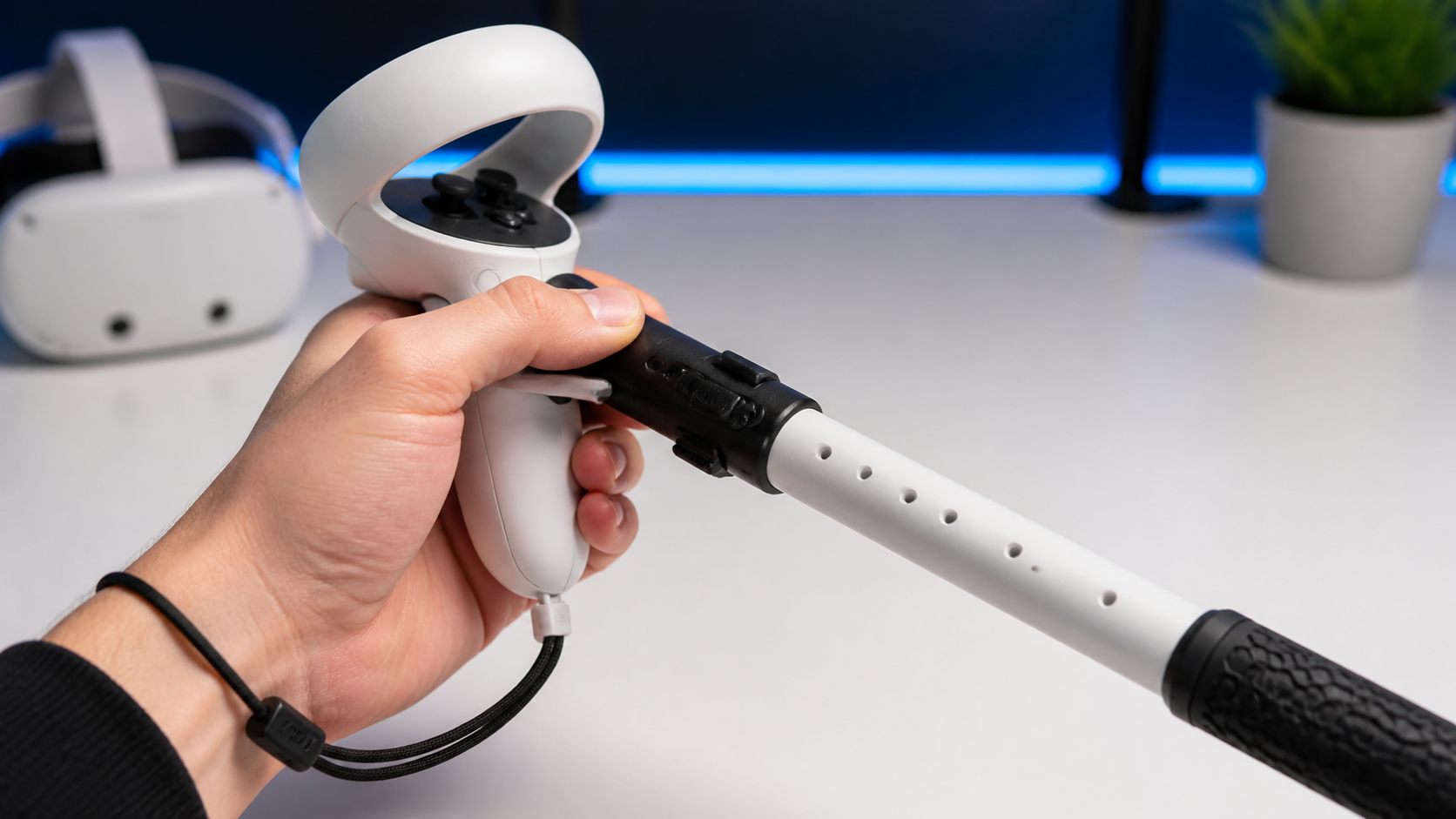 A close-up view of a Quest Touch Plus controller fitted with a long arm extension accessory
