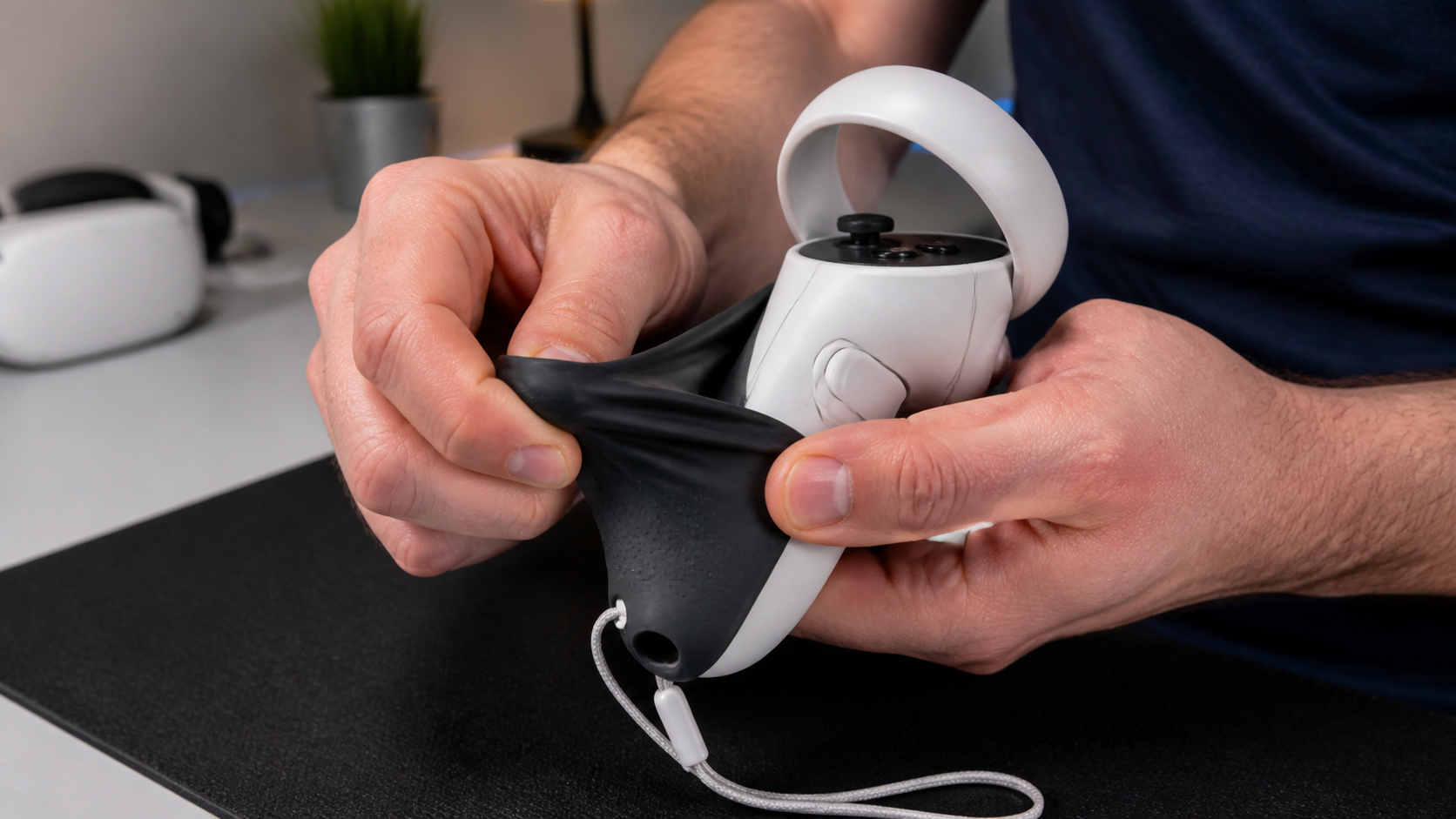 A player's large hands stretching a full silicone cover over a VR controller, showing the initial difficulty of installation