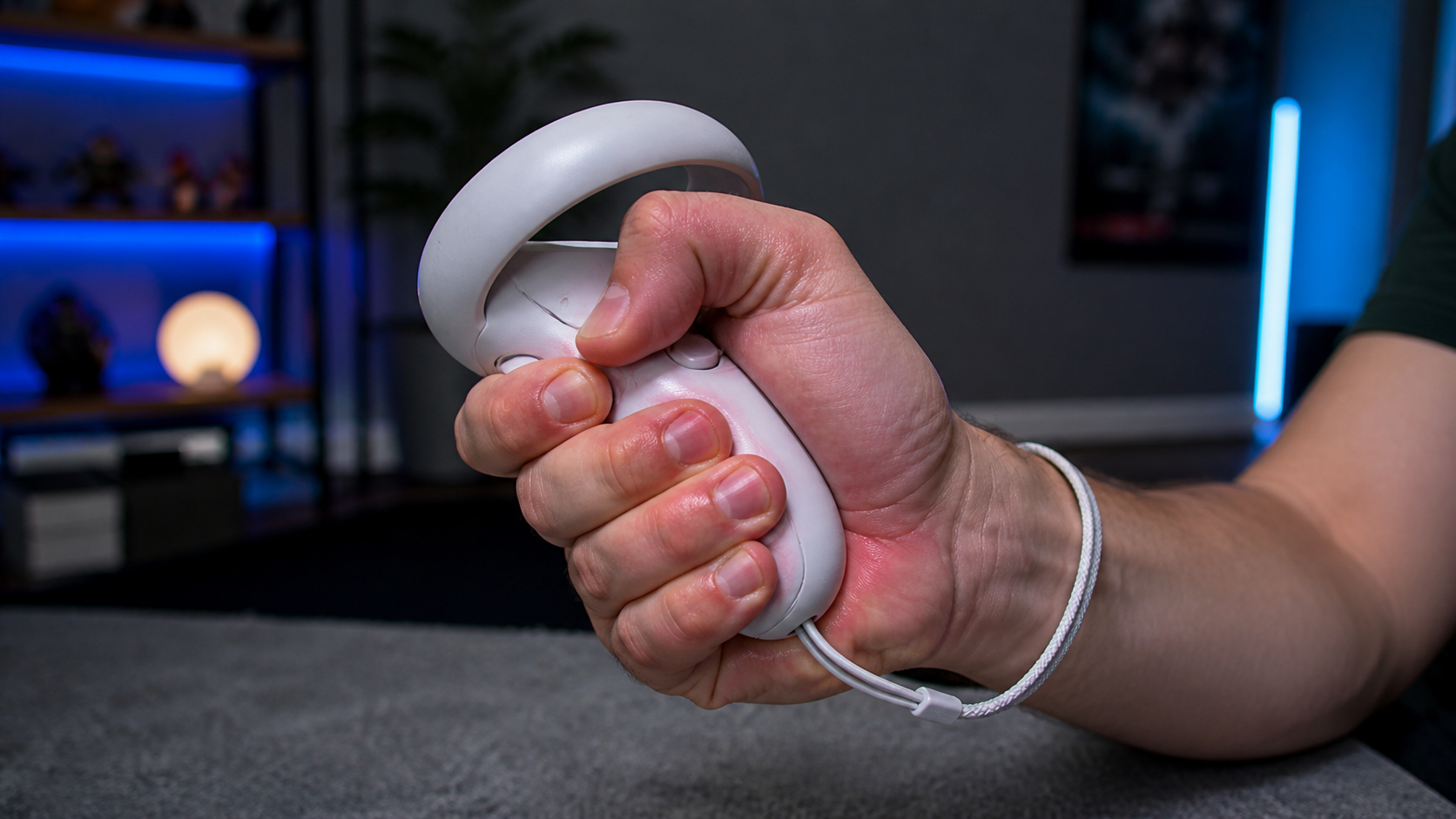 A gamer's hand looking tired and cramped while tightly gripping a standard VR controller during an intense game