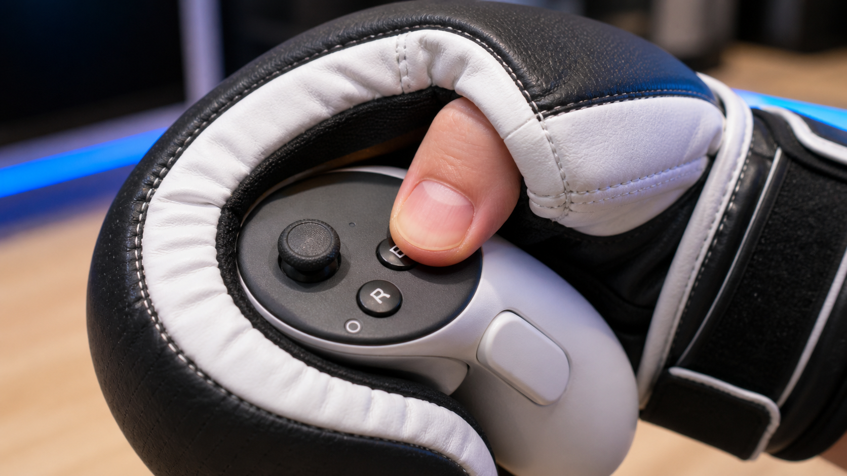 A close-up shot showing a thumb struggling to press a small menu button on a controller inside a VR boxing glove